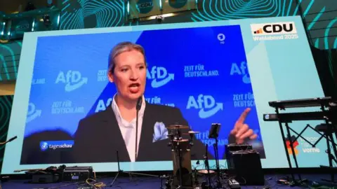 Alice Weidel speaks via a big screen