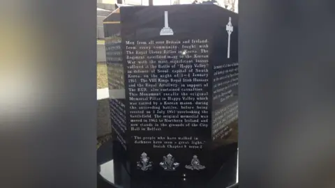 A memorial in black marble with white writing paying tribute to the men from Britain and Ireland who fought with the Royal Ulster Rifles in Korea.