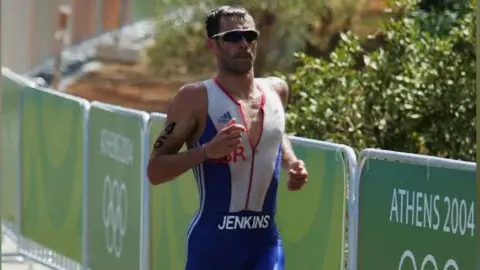 Getty Images Marc Jenkins of Great Britain during the run leg in the men's triathlon
