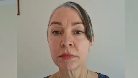 LouLou Palmer A woman withy grey and brown hair