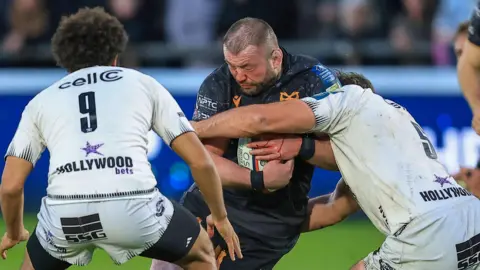 Sam Parry carries the ball for Ospreys against Sharks