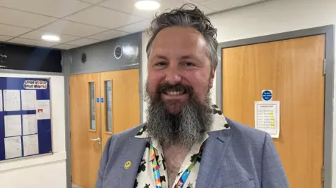 BBC/Emma Glasbey A bearded man