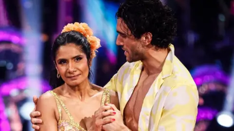 Balvinder Sopal on stage in the studio of Strictly being hugged by dance partner Julian Caillon