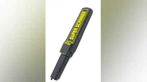 Cardiff council A black handheld metal detector which has the words Super Scanner written on it in bright yellow writing in capital letters 
