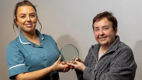 The Royal Wolverhampton NHS Trust Amy Sharkey receiving her award from Louise Nickell