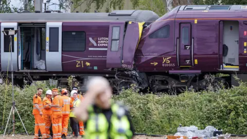 Scene of crash with trains and emergency services in foreground