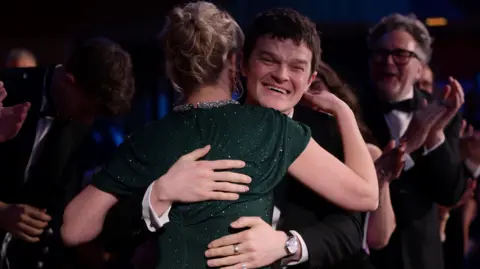 Getty Images Evans and Aramayo embrace