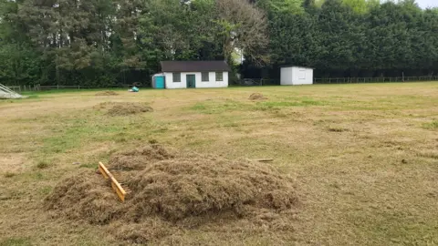 Kevin George/Hodnet & Peplow CC Grass cuttings raked together into a pile