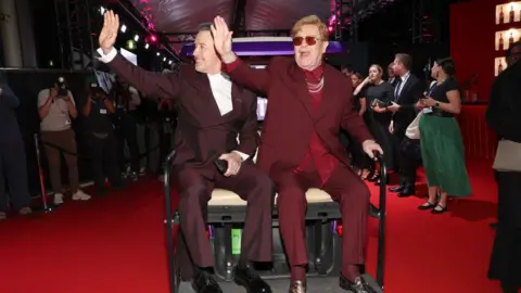 Getty Images Elton John arrives on a buggy at the premiere of his documentary in Toronto