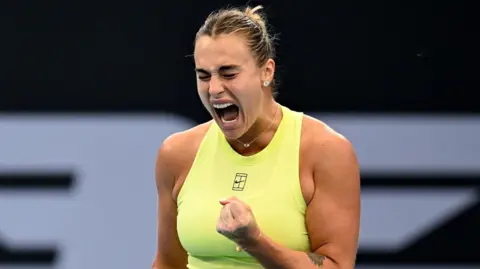 Aryna Sabalenka celebrates with a clenched fist