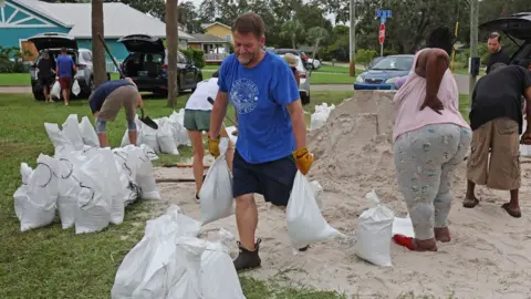 Getty Images People fill sandbags as the state prepares for the arrival of Hurricane Milton on October 07, 2024 in St. Petersburg, Florida.