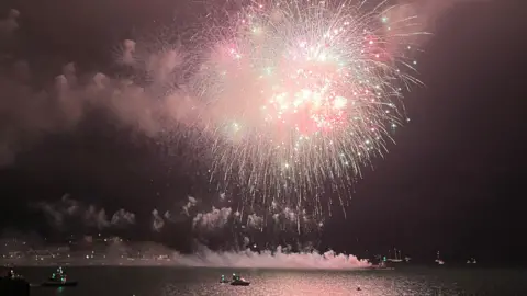 BBC A large firework lights up the night sky over Plymouth sound