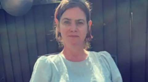 Samantha Lee smiling and looking at camera.
