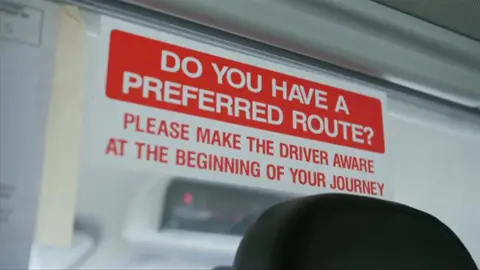 Taxi sign in a window of a hackney carriage