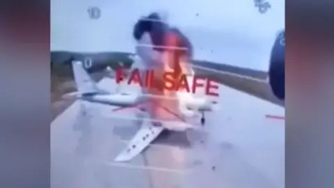 A screenshot from footage purportedly showing drone attack on Russian warplanes