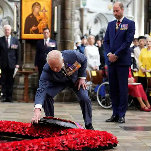PA Media King Charles lays a wreath at the grave of the Unknown Warrior during a service of thanksgiving at Westminster Abbey in London on the 80th anniversary of VE Day.