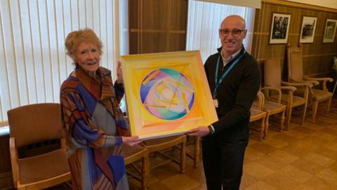 Barbara Hum and Mr Maged Habib with the artwork created by Tom Hume