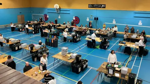 Ballot boxes about to be opened for verification of papers, in a sports hall in Connahs Quay, for the Clwyd constituency.