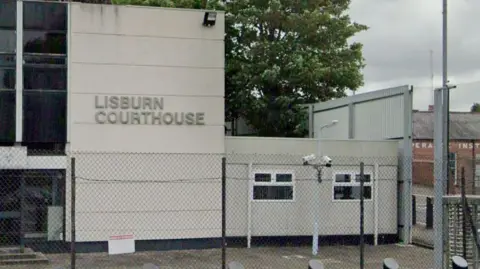 The exterior of a grey building with a sign reading Lisburn Courthouse. 