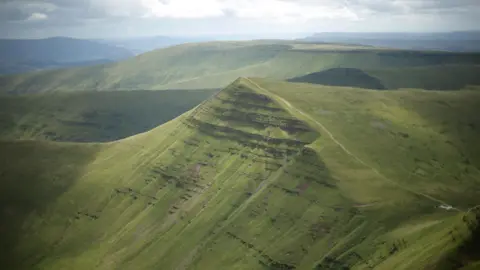 Photograph of the summit of Cribyn mountain as seen from Pen y Fan, Bannau Brycheiniog (Brecon Beacons National Park), Wales. 