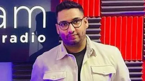 Shafeel Hussain Shafeel Hussain smiling for camera wearing glasses 