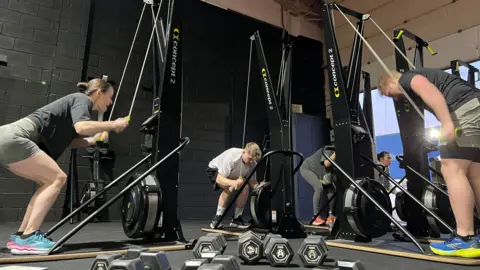 Using the gym equipment in a gym 