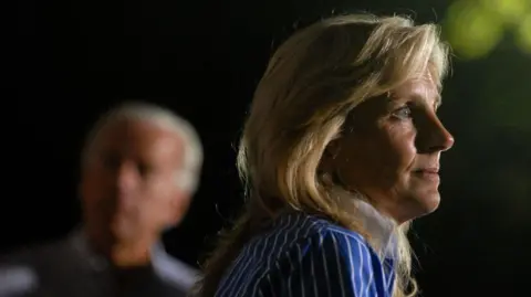 Joe Biden standing with his wife Jill in 2008