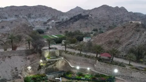 Reuters Aerial shot of mountains in background and landscaped gardens in foreground in Ras al-Khaimah