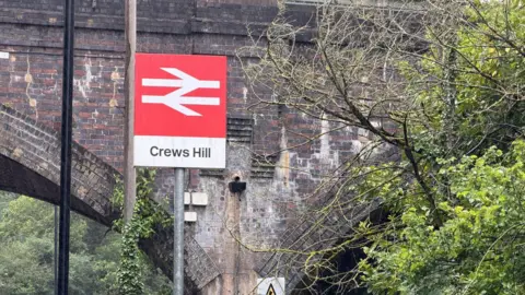 A picture of the Crews Hill railway station sign