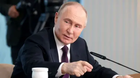 Vladimir Putin speaks during a meeting with senior editors from international news agencies in Saint Petersburg