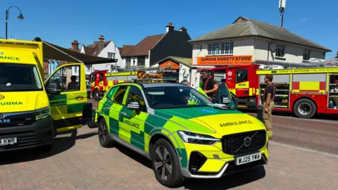 Ambulances and fire engines are at the scene of a gas leak outside a shop called 'Gurkha Variety Store'