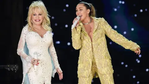 Getty Images Dolly Parton and Miley Cyrus performed at the 61st Annual Grammy Awards in 2019.