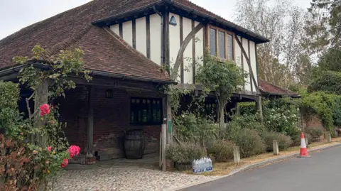 PA Media Bottled water outside a house in Benenden.