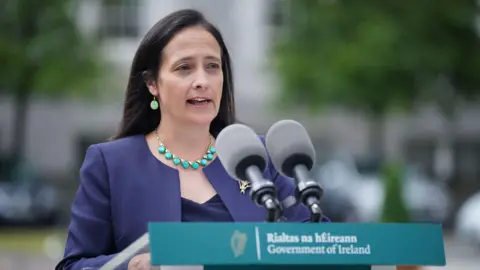 PA Media Catherine Martin speaking behind a podium 