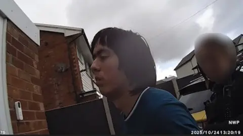 North Wales Police A still image from North wales Police body worn camera footage at the time of Tristan Roberts' arrest on suspicion of the murder of his mother.