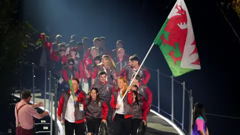 PA Media Welsh team carrying their flag
