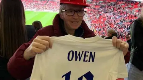 Wendy Owen with her legacy cap and England Shirt which reads Owen, 12.