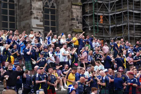 PA Media fans sing on the steps of Cologne Cathedral before the match against Switzerland