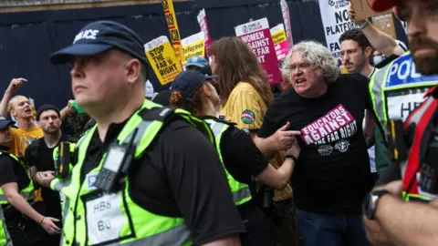 Protesters held up Stand Up to Racism placards ahead of the debate 