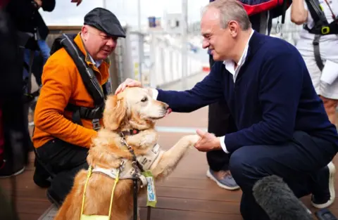 PA Media Ed Davey with a dog 