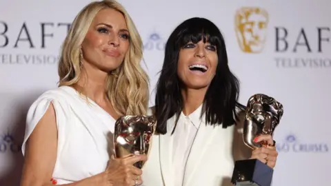 EPA Tess Daley (L) and Claudia Winkleman (R) hold the award for the Best Entertainment category for 'Strictly Come Dancing' during the 2024 BAFTA TV Awards at the Royal Festival Hall in London, Britain, 12 May 2024. 