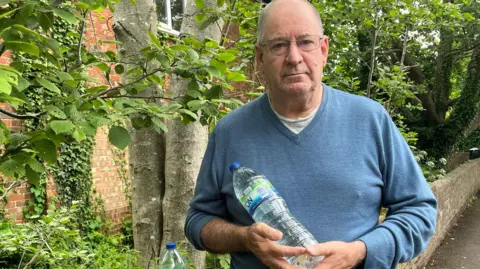 BBC/Julia Gregory Raymond Vincent with bottled water in Bramley