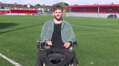 BBC George Dowell in his wheelchair at Worthing FC's stadium