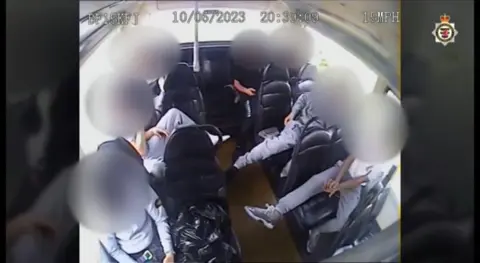 Avon and Somerset Police Boys sitting at the back of the bus with their faces blurred