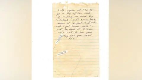 Gloucestershire Police A piece of old yellowy-coloured lined paper which has been ripped out of a notebook. The paper has two dark hairs on it. The note reads: "Left again at 1.30 to go to the top of the road. If I have no work by 2 o'clock I will come back down at 10 past 2 if not and I get some work I will be back at 2.30pm. Can't wait to see you darling love you Carol XXX.'