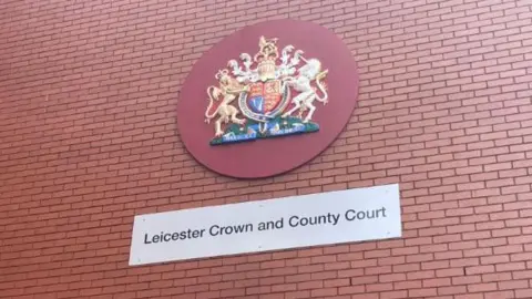 Leicester Crown Court signage on a red brick wall