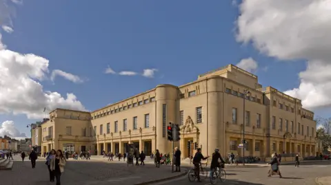 James Brittain Exterior of the Weston Library on Broad Street. People are seen walking and riding bikes. It is a clear day.
