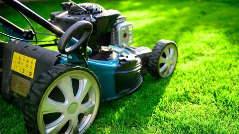 A lawnmower over grass 