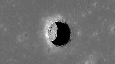 A picture of the Moon's surface with an opening called a "lunar pit"