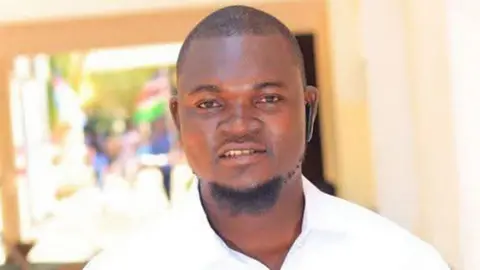 A head and shoulders image of Albert Ojwang wearing a white shirt.